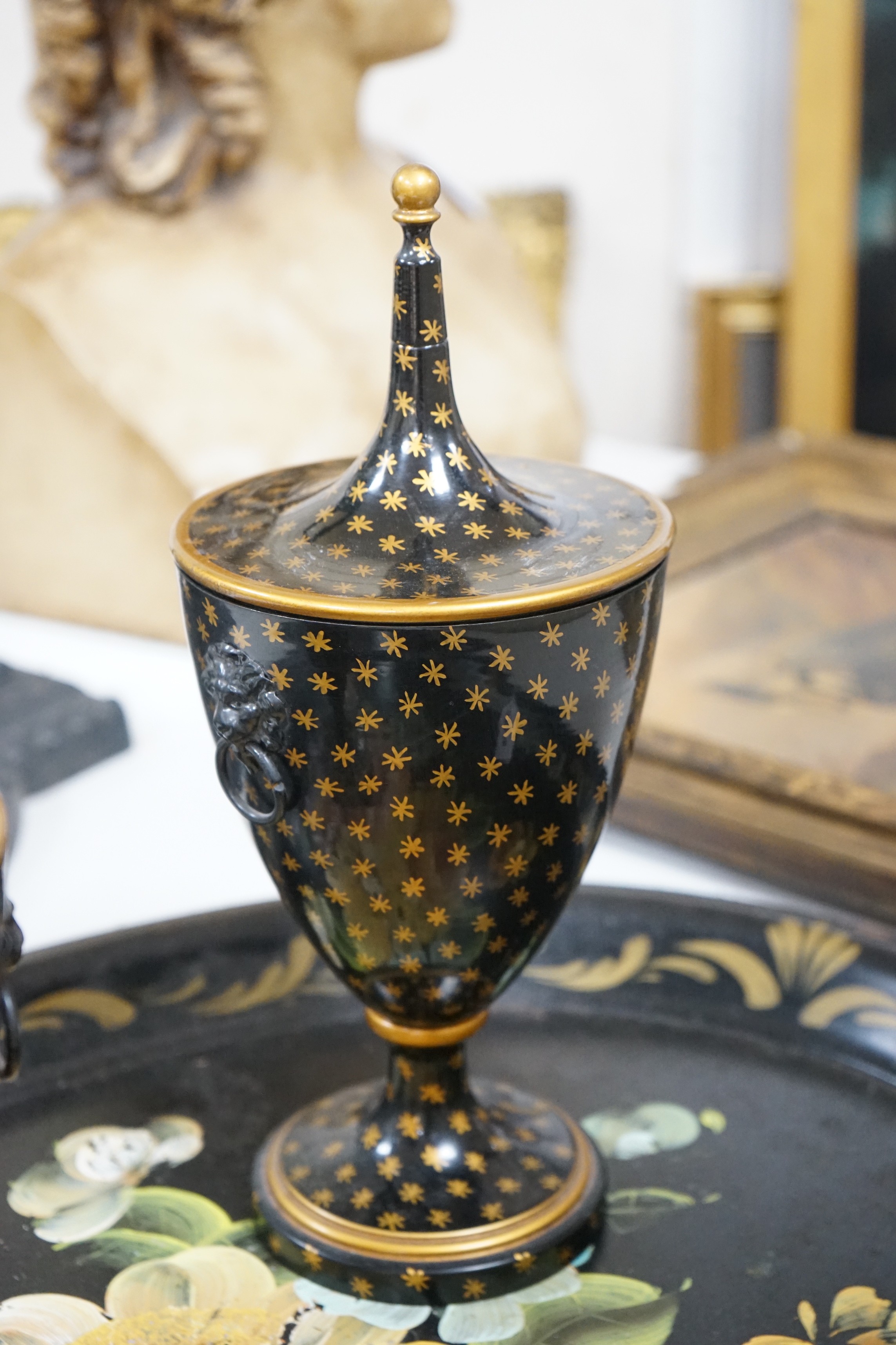 A pair of lidded painted toleware vessels, together with a painted tin toleware tray, 65cm long (3)